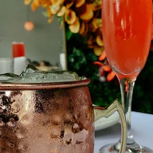a cocktail and a copper mug