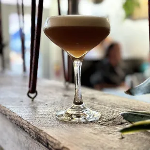 a drink in a glass on a bar