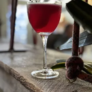 a glass of wine sitting on a ledge