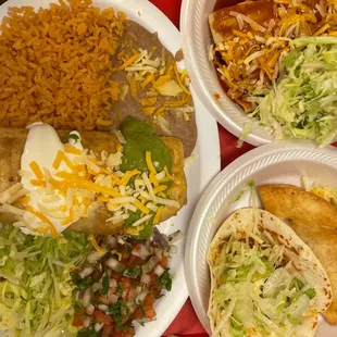 One platter has a chimichanga(ground beef) beans and rice. Two chicken enchiladas,a puffy  taco