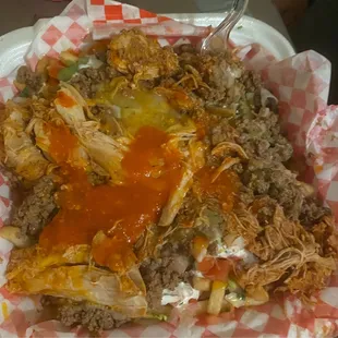 Beef and chicken super fries with hot sauce