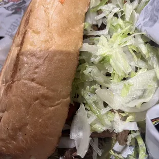 a sandwich with meat and lettuce