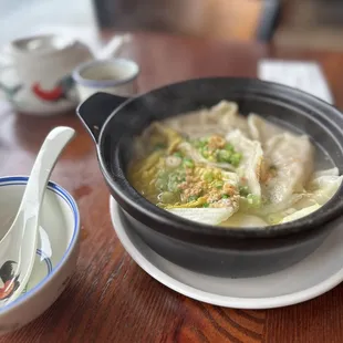 a bowl of soup and a spoon on a table