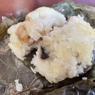 a close up of a piece of food on a leaf