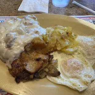 Country Chicken Fried Steak Platter With 2 Eggs , Potatoes and Toast.