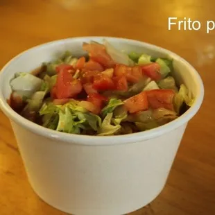 a salad in a paper cup