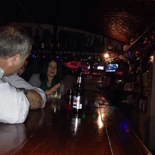 a man and a woman sitting at a bar