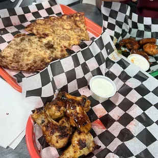 A dozen of half mango habanero, half Buffalo wings, and their lunch special of two slices of pizza