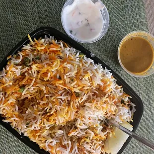 Vegetable Dum Biryani with a side of Riata (yogurt salad) and Salan (spicy gravy)