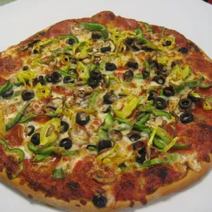 a pizza with olives and peppers