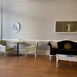 a living room with a couch, table, and chairs
