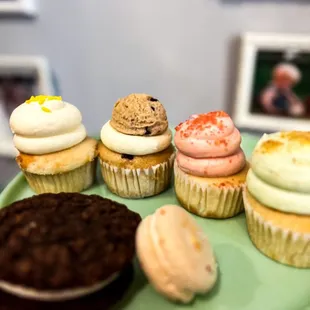 a variety of cupcakes on a green plate