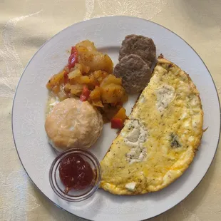 Fancy egg omelette potatoes sausage and a biscuit,