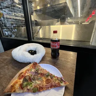 a slice of pizza on a paper plate