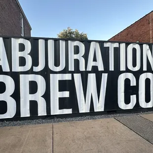 a sign that reads abjuration brew co