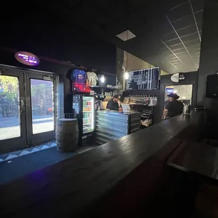a bar with a man standing at the counter