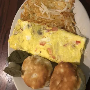 Omelet with mushrooms, onions, and tomatoes with biscuits and hash