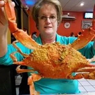 a woman holding a crab