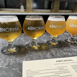 four glasses of beer on a table