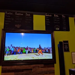 Inside. Wall menus. African music videos playing on the TV.