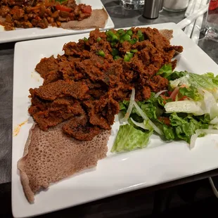 Dirkosh fir-fir. Oven-dried pieces of injera marinated with awaze sauce and Abol spices. Veggie version. $10.99.