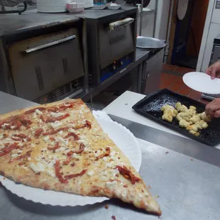 a slice of pizza being prepared