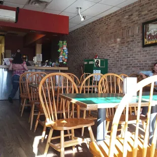 a dining room with wooden chairs and tables