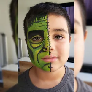 Young boy painted as Frankenstein before heading out to trick or treat.