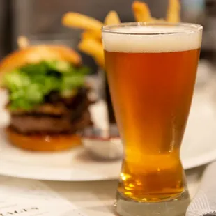 a glass of beer and a burger