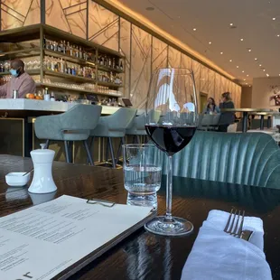 a glass of wine and a menu