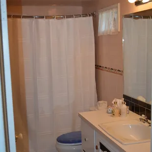 Front House Bathroom with tub and shower.