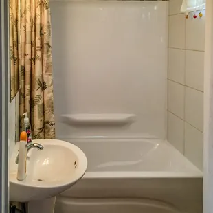 Little Red House Studio remodeled bathroom with bath and shower.