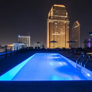 a swimming pool on a rooftop at night