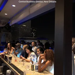 a group of people sitting at a bar