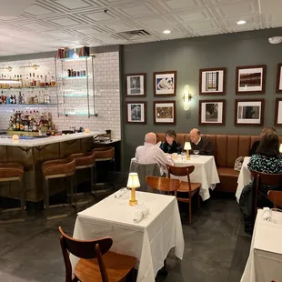 people sitting at tables in a restaurant