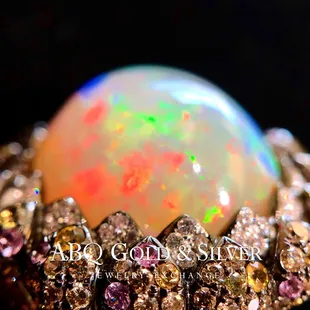 Channeling intergalactic energy, this ring promises the moon and more! 22 carat fiery opal sprinkled with sapphires and diamonds.