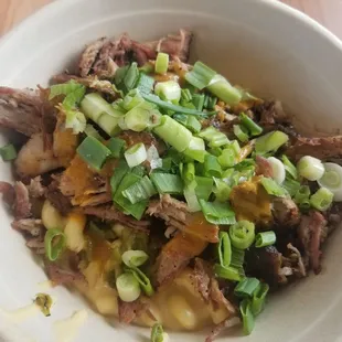 "Martin Special" with mac and cheese topped with pulled pork, green Chile and green onions