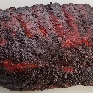 A full slab of our delicious BBQ ribs.  We smoke these bad boys for several hours, basting them with our signature red chile and BBQ sauce.