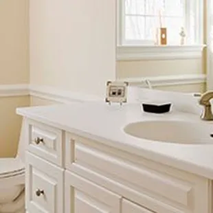 a bathroom with a white sink and toilet