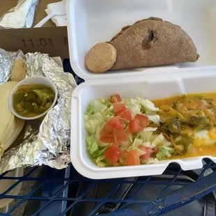 Smothered roast beef burrito, chicken tamale with green sauce, biscochitos, and an apple empanada.