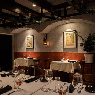 a dining room with white tablecloths and white tablecloths