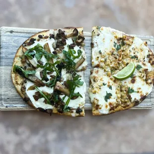 Flatbread pizza. Half wild mushroom and arugula, half Elote.