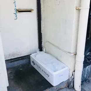 a white refrigerator sitting outside of a building