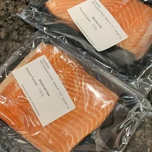two pieces of salmon wrapped in plastic