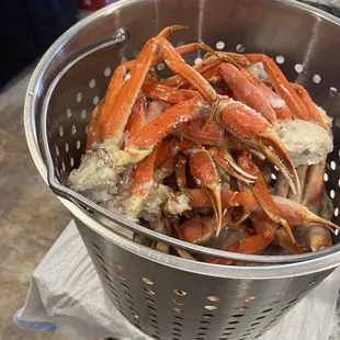 a colander full of crab legs