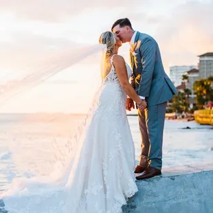 Recently married Couple getting a photo during sunset at Waikiki