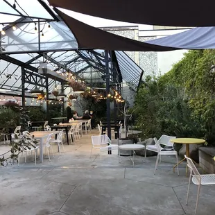 a patio with tables and chairs