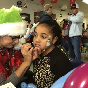 Reme the Elf doing Face Painting!