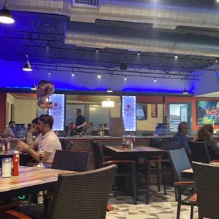 people sitting at tables in a restaurant