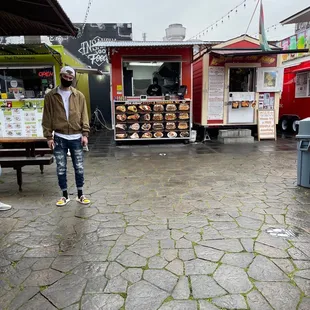 a man walking in front of a food truck